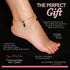 A foot adorned with a 14k gold-filled anklet featuring red and black crystal beads. This Genuine Jet Black Azabache jewelry piece is waterproof, nickel-free, anti-allergic, and offers spiritual protection against the evil eye.